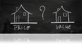 Two homes drawn on a chalkboard with Price under one and Value under the other and a question mark between them